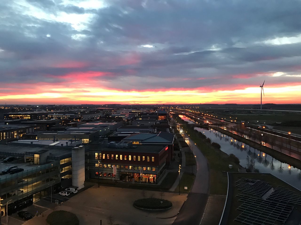 city, transportation, cloud - sky, sky, high angle view, cityscape, illuminated, connection, architecture, city life, traffic, sunset, building exterior, bridge - man made structure, built structure, night, aerial view, travel destinations, outdoors, no people, urban skyline, road, skyscraper