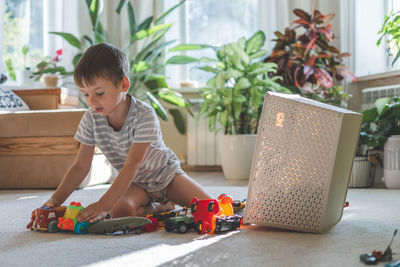 Side view of boy sitting on table