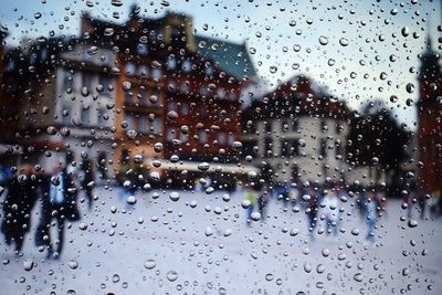 City seen through wet window during rainy season