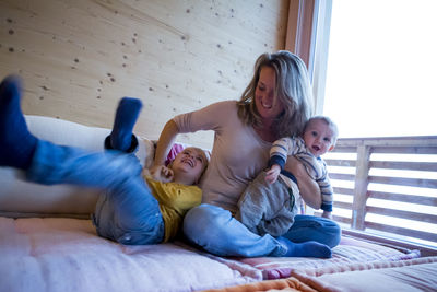 Mother playing with her little sons at home