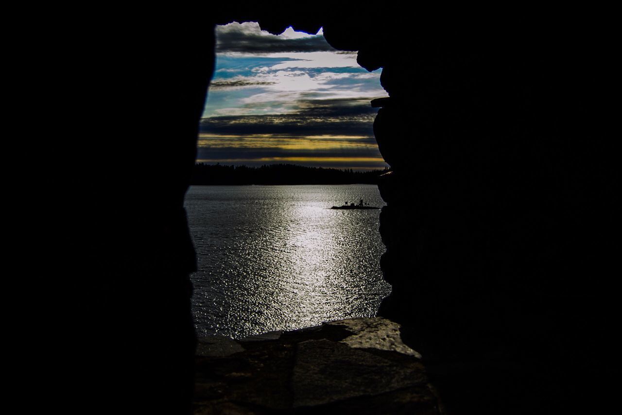 SCENIC VIEW OF SEA AGAINST SKY SEEN THROUGH ROCK