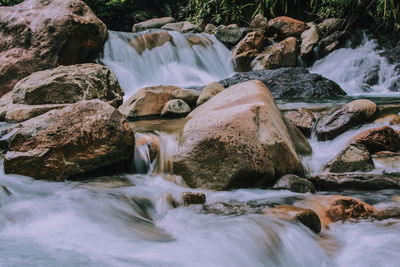 Scenic view of river flowing through rocks
