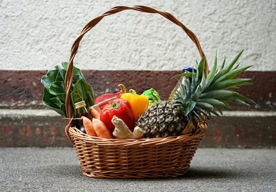 Close-up of vegetables and fruits in wicker basket