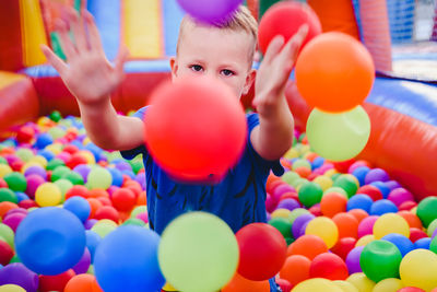 Full length of a boy playing with balloons