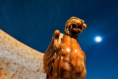 Close-up of statue against blue sky