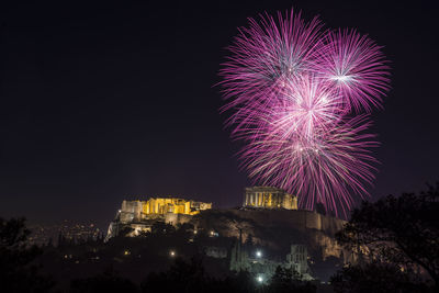 Low angle view of firework display at night