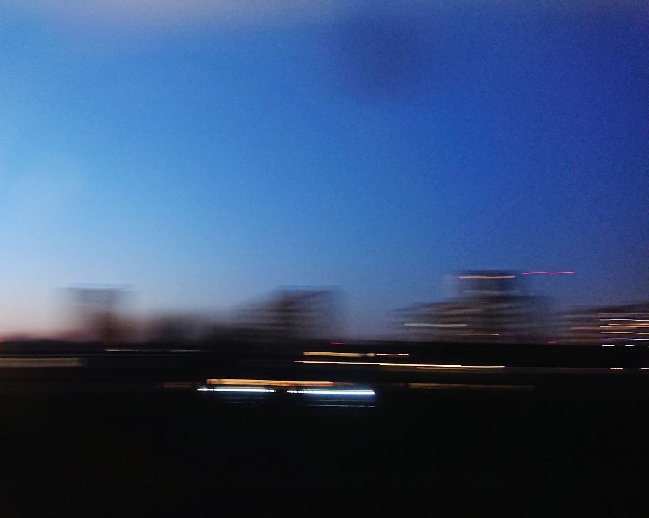 BLURRED MOTION OF VEHICLES ON ROAD IN CITY