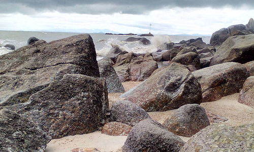 Rock formations in sea against sky