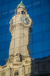 Low angle view of statue against building in city