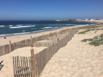 Scenic view of beach against clear sky