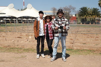 Full length of couple standing on field