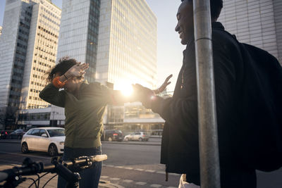 People on street amidst buildings in city