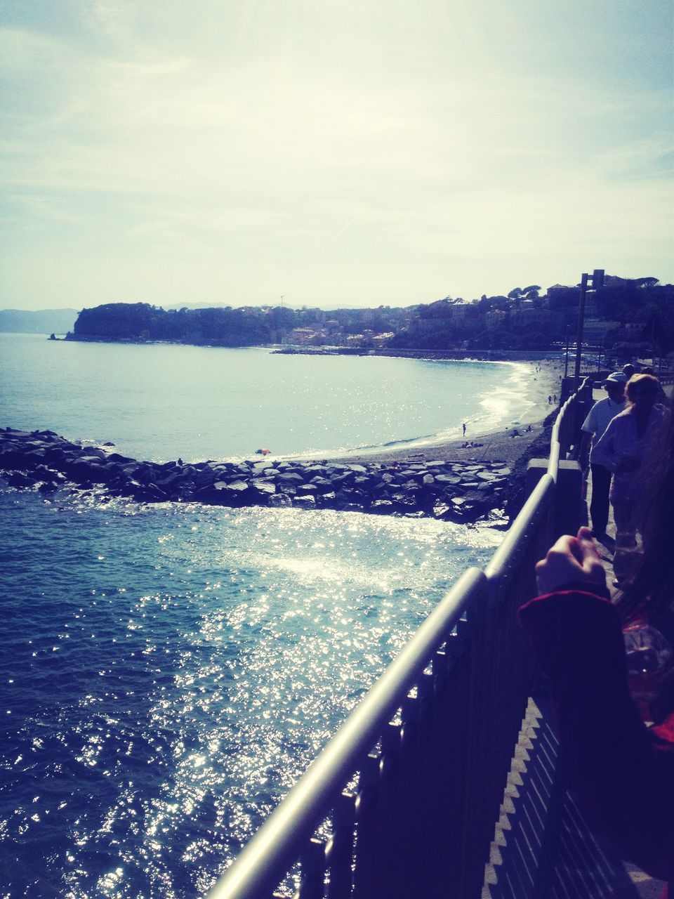 water, sea, sky, railing, lifestyles, leisure activity, nautical vessel, horizon over water, men, nature, transportation, scenics, beach, pier, rear view, sunlight, standing, beauty in nature