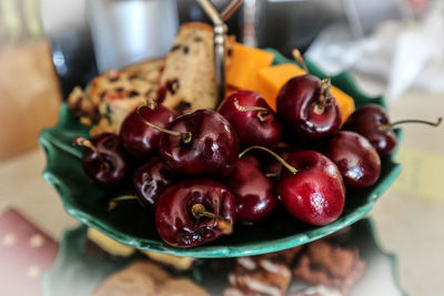 Close-up of cherries in plate on table