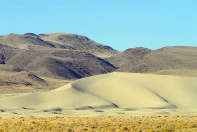 Scenic view of mountains against clear blue sky