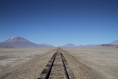 Railroad track leading towards mountain
