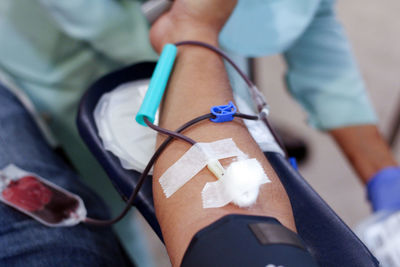 Cropped image of man donating blood in hospital