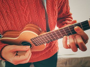 Close-up of man playing guitar