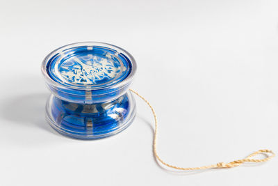 Close-up of blue yoyo against white background