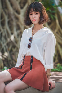 Portrait of beautiful young woman standing outdoors