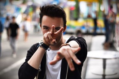 Close-up portrait of man gesturing in city