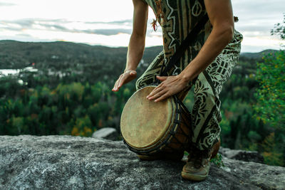 Low section of person standing on rock