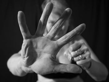 Close-up of human hand against black background