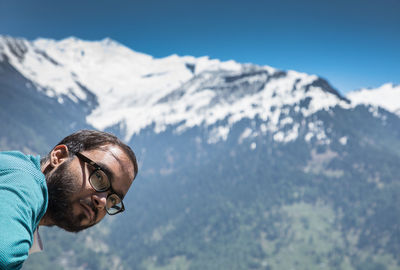 Portrait of young man with sunglasses on mountain