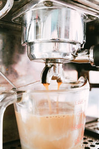 Close-up of coffee in container on espresso machine