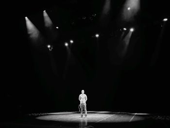 Man standing in illuminated light