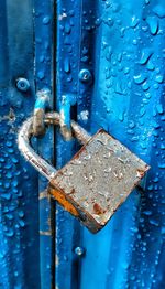 Close-up of padlock on blue door