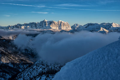 Scenic view of snowcapped mountains against blue sky