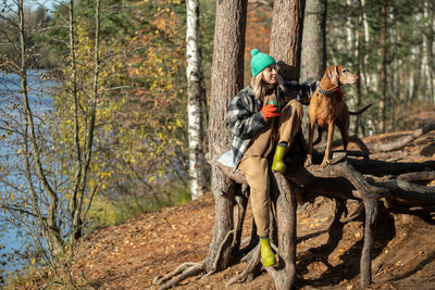 Rear view of woman standing in forest