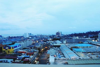 High angle view of road by buildings against sky