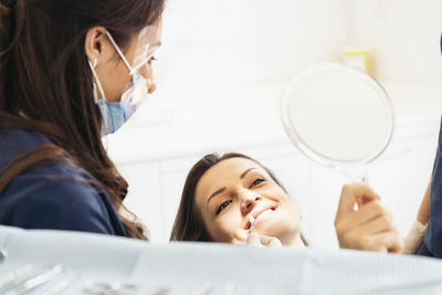 Female dentist operating patient in hospital