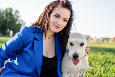 Portrait of young woman with dog