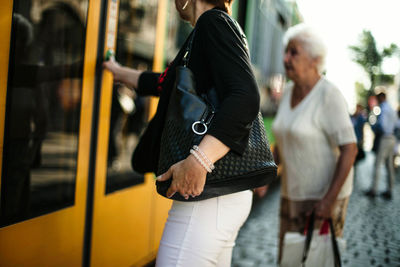 Rear view of people at tram station