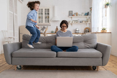 People sitting on sofa at home