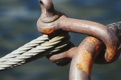 Close-up of rope tied on rusty metal