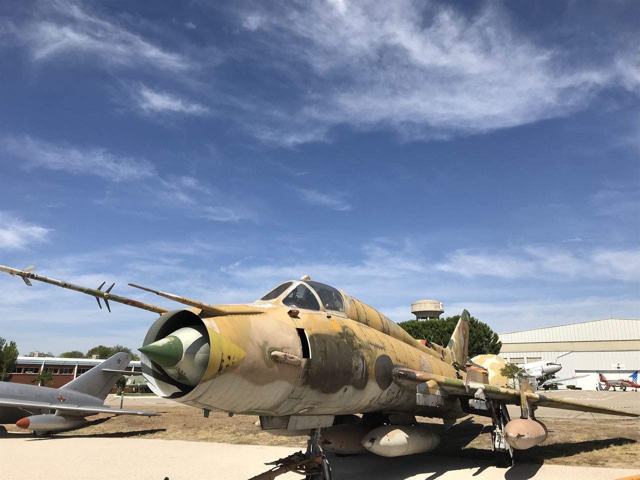 sky, cloud - sky, mode of transportation, transportation, sunlight, day, nature, military, no people, outdoors, air vehicle, land vehicle, land, airplane, shadow, construction industry, sunny, airport, field, metal, plane, construction equipment