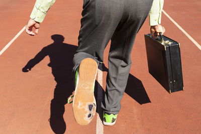 Low section of men standing on street