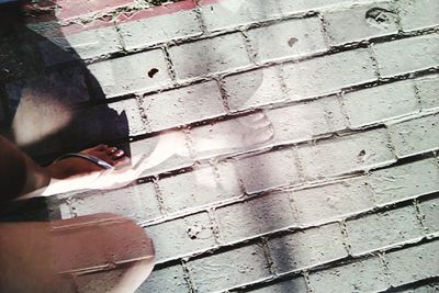 Low section of woman standing on tiled floor