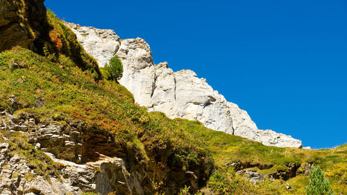 Scenic view of rocky mountains against clear blue sky