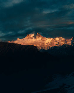 Scenic view of snowcapped mountains against sky during sunset