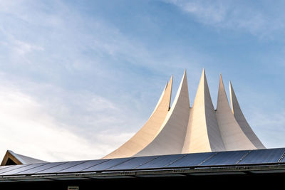 Tempodrom - low angle view of modern building against cloudy sky