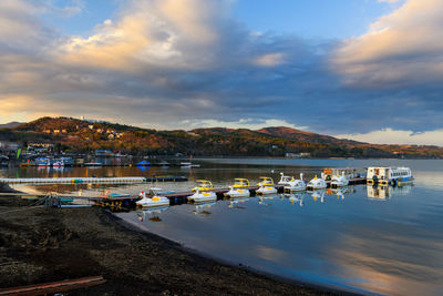 Yamanaka lake with floating recreation and tourist boats at sunset, yamanashi, japan. 