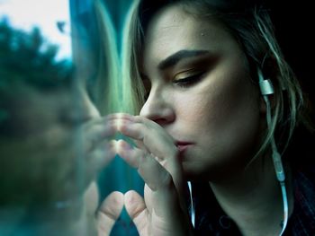 Close-up portrait of young woman looking away