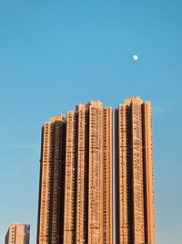 Low angle view of modern building against clear blue sky