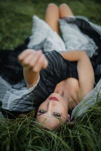 Low section of woman relaxing on grass