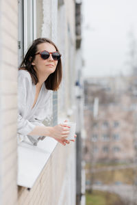 Smiling woman leaning out window